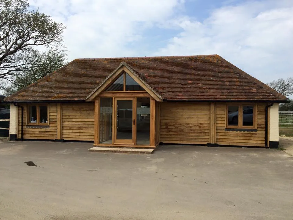 a large wooden building with a brown roof